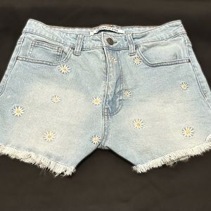 Light wash blue jean shorts with embroidered daisies